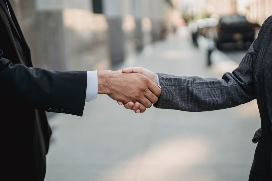 Two people shaking hands in a business meeting